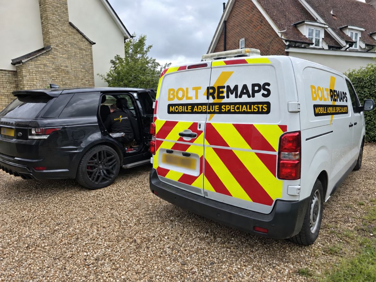 Bolt Remaps van parked on a gravel driveway while a technician works inside a Range Rover Sport