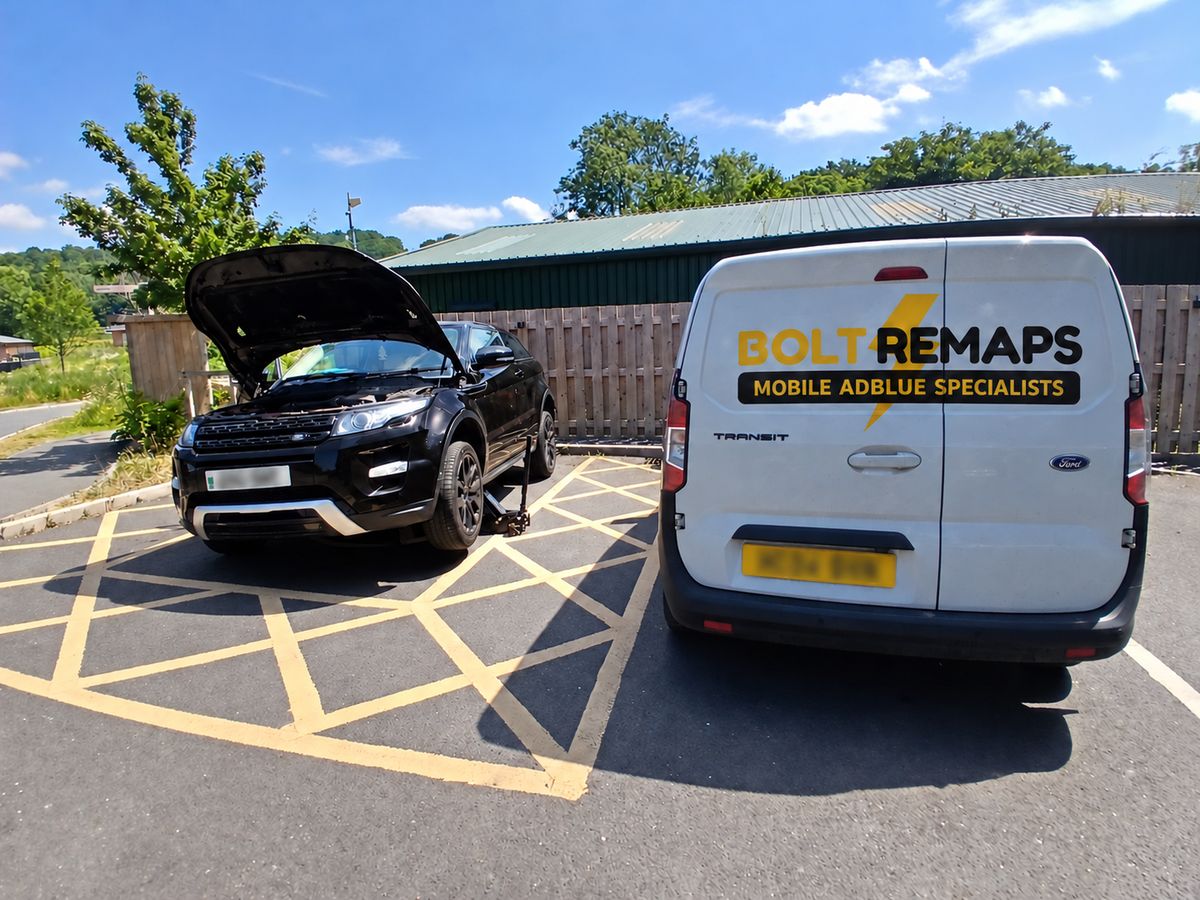 Bolt Remaps van next to a Range Rover Evoque with its bonnet open in a car park