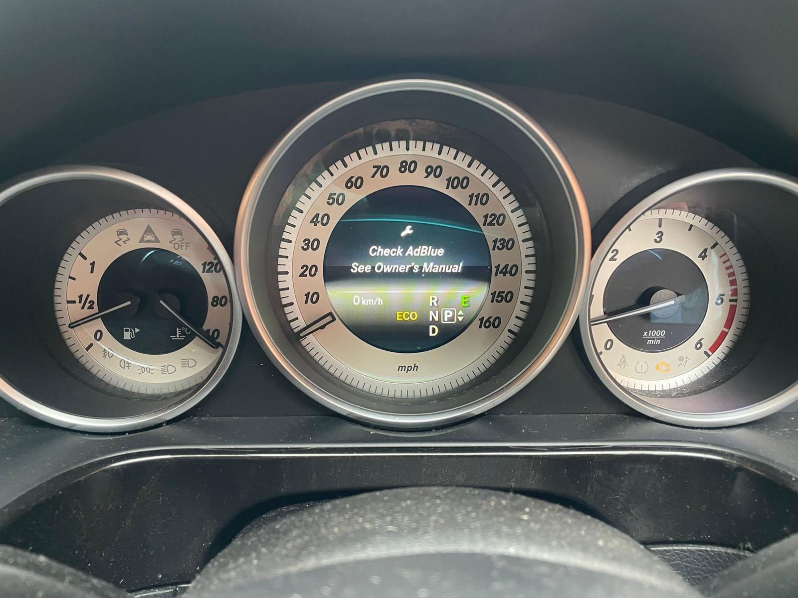 Mercedes-Benz dashboard showing AdBlue warning: “Check AdBlue. See Owner's Manual”