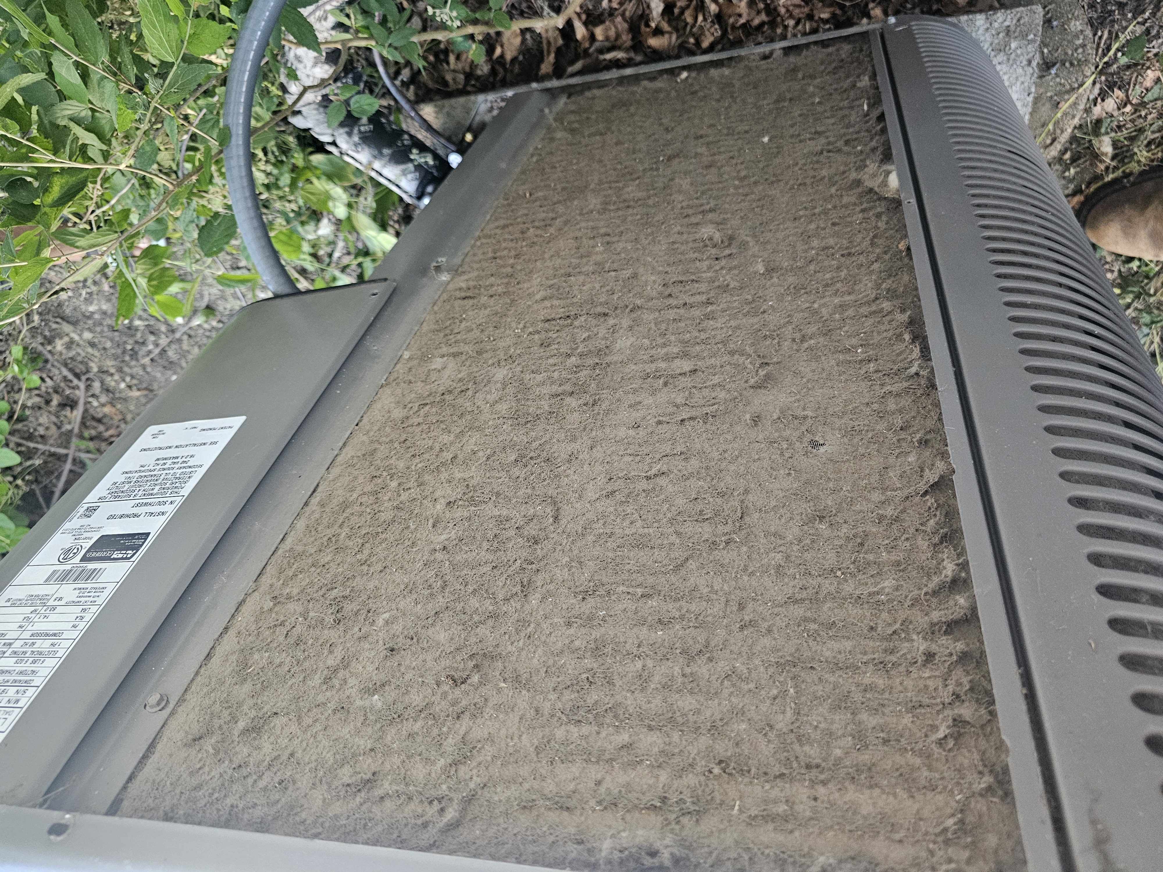 Severely dirty residential condenser coil inspected by A Plus Air