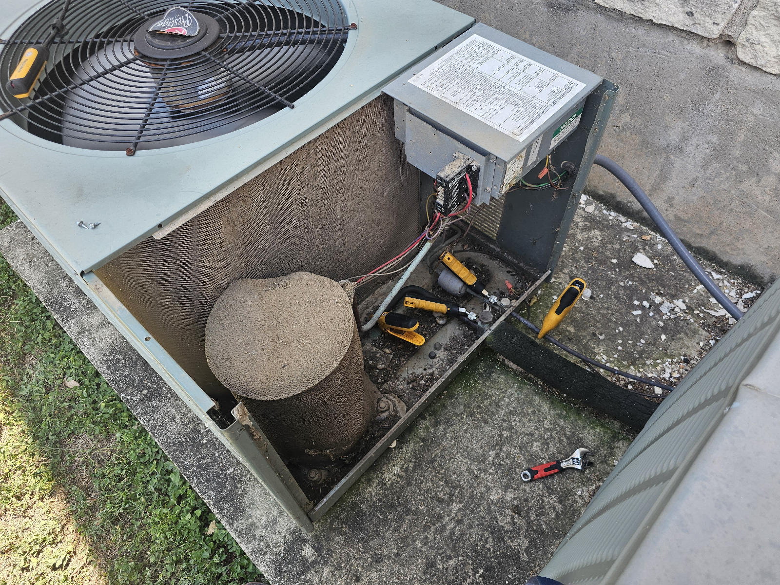 Open residential condenser unit with service tools during an A Plus Air call in Allen, TX