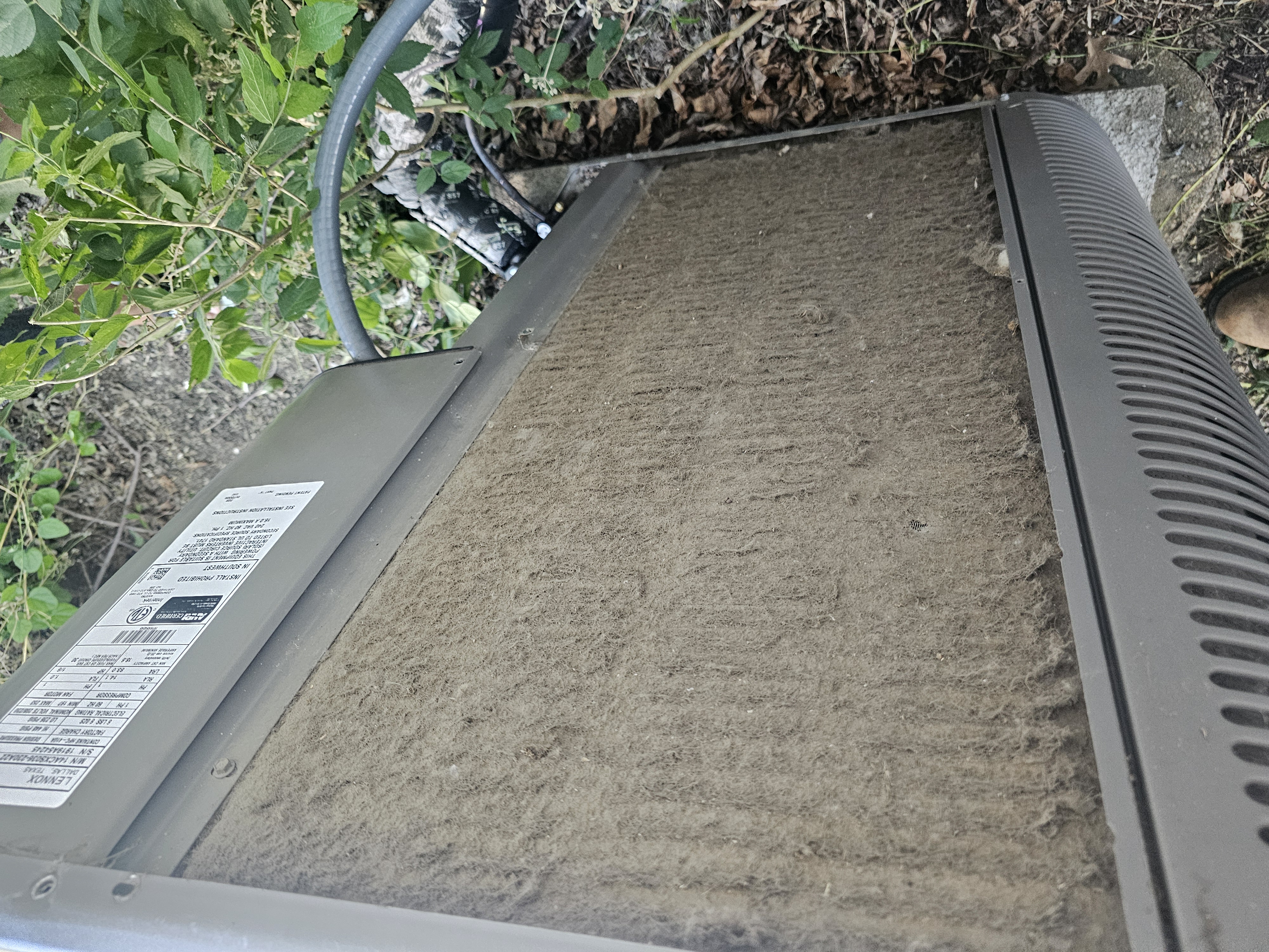 A Plus Air technician diagnosing an outdoor AC condenser